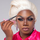 Model applying Mo-Beauty Shop's Divinely Defined Thick, Angled Tip Brow Pencil + Brush in the Grey (soft black) shade.
