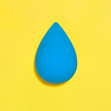 Blue makeup sponge on a yellow background
