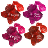 Texture image of Mo-Beauty Shop's Mo-Jelly Blush + Lip Tint in the shades Sherbet (a buildable coral color), Berry Crush (a buildable berry-pink color), Passion Pop (a buildable  pink color), and Chili Crisp (a buildable red color). 