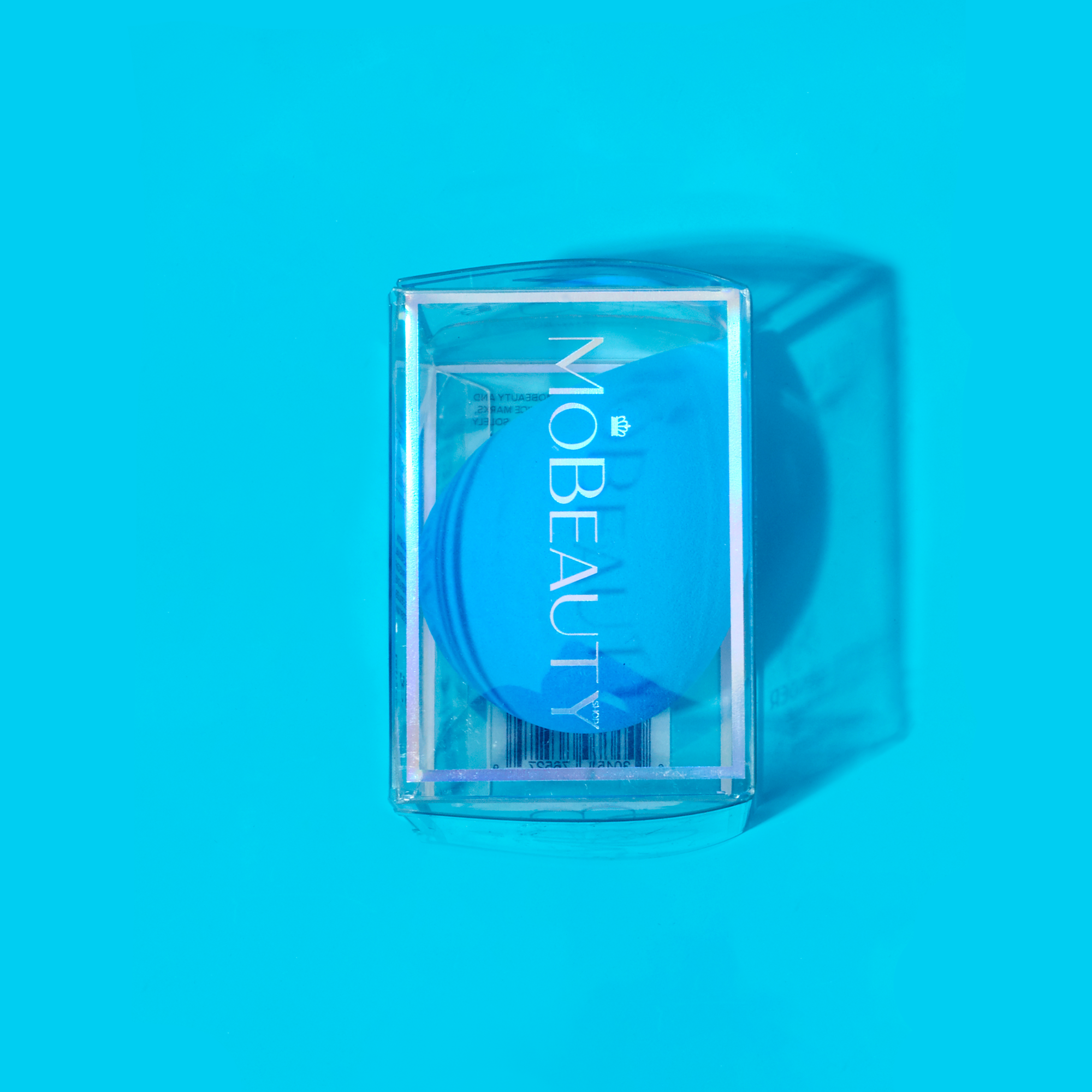 Mo-Beauty Shop's teardrop-shaped, latex-free Cosmetic Blender in the color Blue, sitting inside its clear packaging.