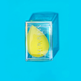 Mo-Beauty Shop's teardrop-shaped, latex-free Cosmetic Blender in the color Yellow, sitting inside its clear packaging.
